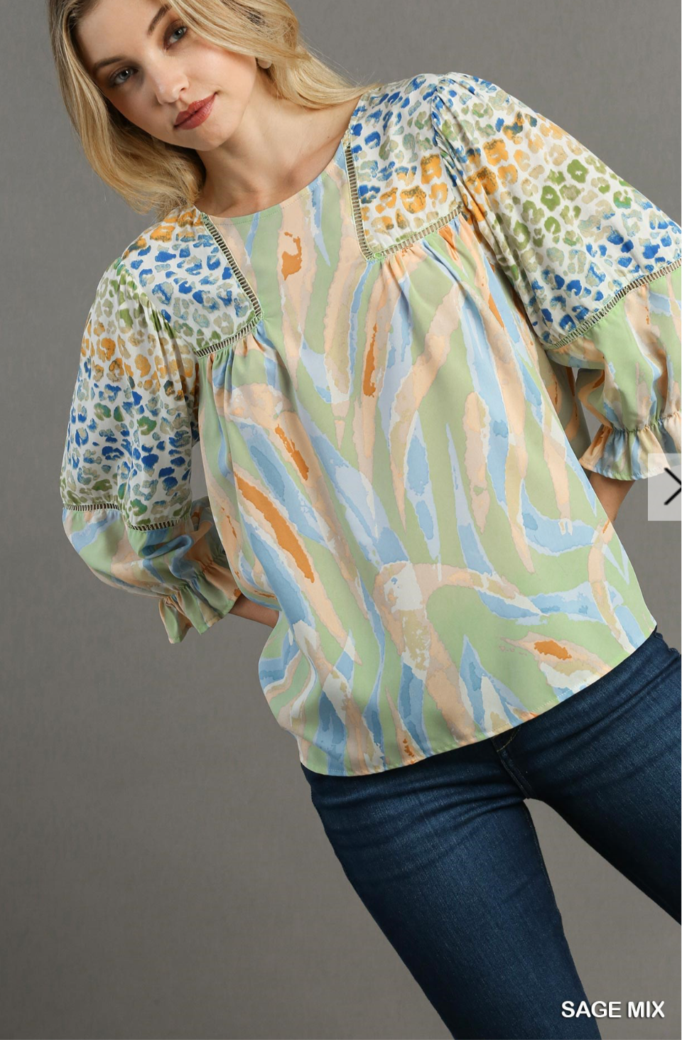 Umgee Mixed Print Top with 3/4 Sleeves and Lace Trim. Features Open Split Back Details with Button Closure